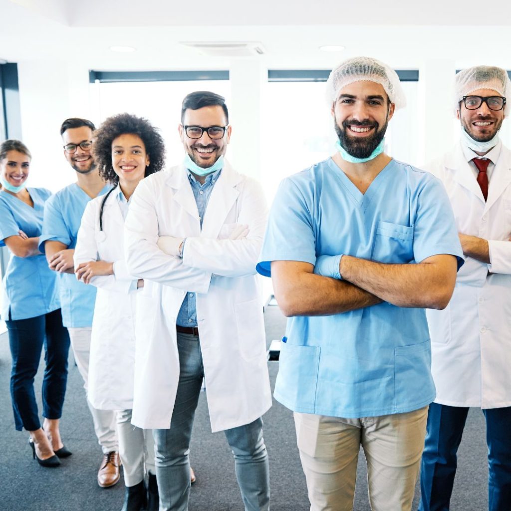 Dental staff standing in a row smiling